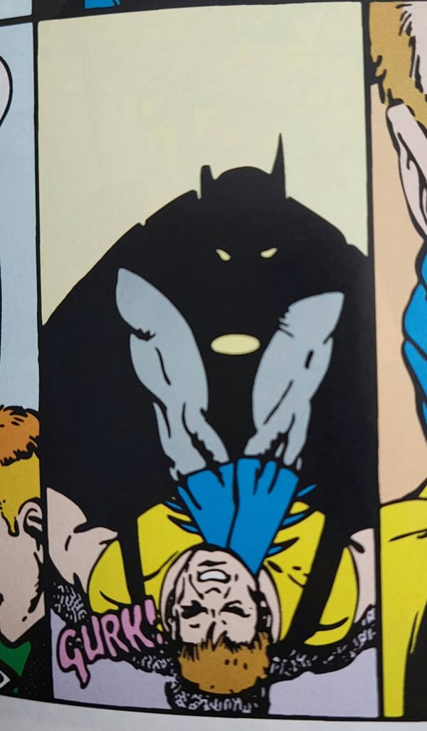 Batman, shown in silhouette, chokes Rick Flagg.